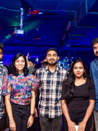 A group of friends posing for a photo inside the pub.