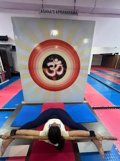 This advanced hip-opening pose, Supta Kurmasana, is being explored with the help of a bamboo stick. Props can be used creatively to find new depths in your practice.