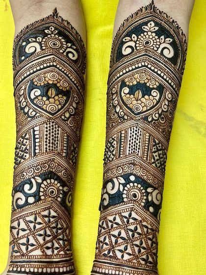 I love playing with contrast in my bridal designs. Here, bold floral elements are set against dark, negative-space patterns, making the details pop and creating a dramatic effect on the legs.