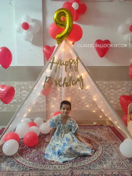 Our birthday tent setup is a wonderful surprise for any child. We decorate the space with heart-shaped balloons and a number foil balloon to make their day feel extra special.