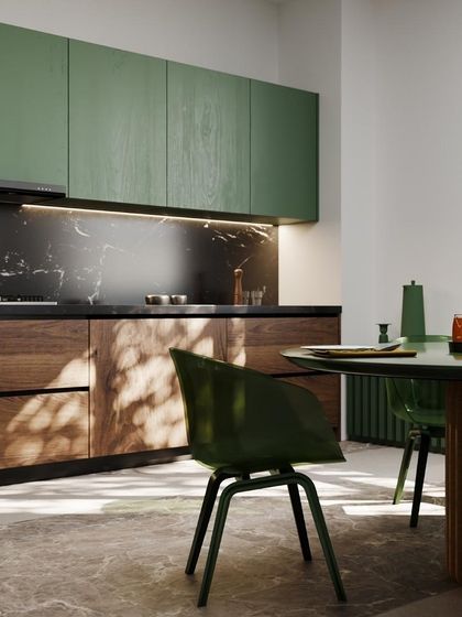 A seamless kitchen blends all elements harmoniously. This design uses green and wood cabinets with a dark marble backsplash to create a cohesive and uninterrupted flow, giving it a clean and modern aesthetic.