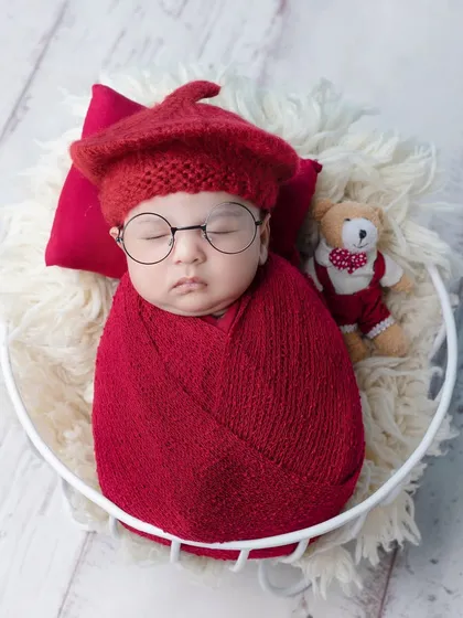 A touch of fun with tiny glasses and a beret on this sleeping newborn.