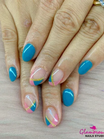 A chic and colorful design combining solid teal nails with accent nails featuring a color-blocked pattern of teal and pink separated by a gold stripe.