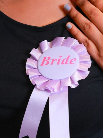 A simple and sweet "Bride" badge is a lovely accessory for the leading lady. It's an elegant way to make her stand out during her bridal shower or bachelorette festivities.