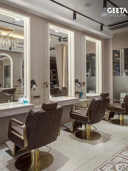 Our Ahmedabad salon features a dedicated men's grooming area with classic leather barber chairs and gold accents, creating a vibe of timeless elegance.