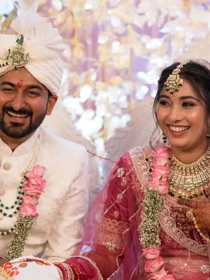 A candid moment of shared laughter between the bride and groom during their wedding festivities.