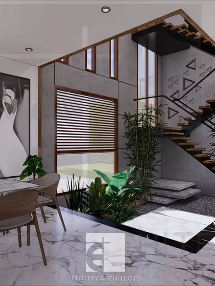 An interior view of a proposed bungalow in Lonavala, designed as a serene weekend home. This image highlights the integration of nature within the living space, with an open-to-sky courtyard and staircase that serves as a central, light-filled feature connecting the different levels of the home.