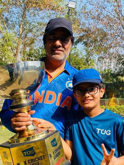 A proud moment for a player and his father, holding the championship trophy. These are the memories that last a lifetime.