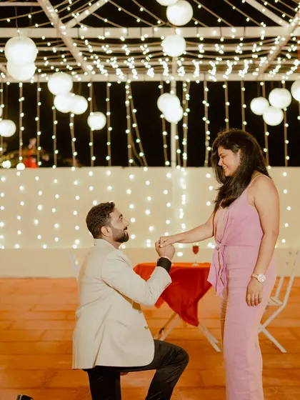 A surprise proposal under a canopy of lights. I help couples plan these moments to ensure the setup is perfect and the memory is captured beautifully.