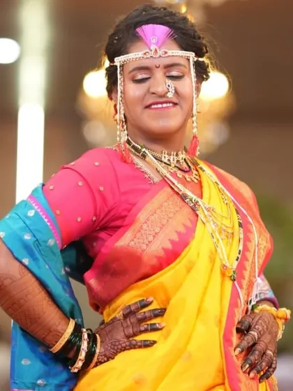Confidence and joy. This bride is striking a pose, and her dark mehendi stain is the perfect accessory to her vibrant wedding attire.