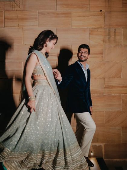 A candid moment of the couple walking together, the groom's loving gaze and the bride's gentle smile telling a story of affection.