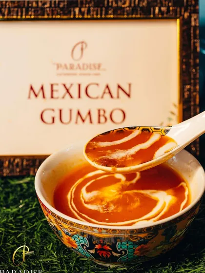 A spoonful of our rich and savory Mexican Gumbo soup. The creamy swirl on top adds a touch of elegance to this rustic and comforting dish.