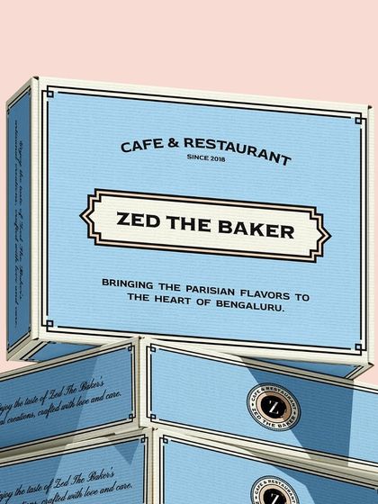 A stack of my signature blue pastry boxes, bringing Parisian flavors to the heart of Bengaluru, ready for delivery or pickup.