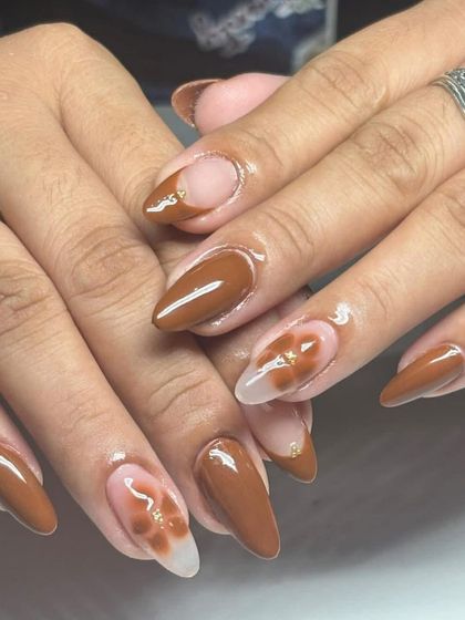 A brown and nude set with a blooming gel flower effect. This technique creates a soft, blended look that is very artistic.