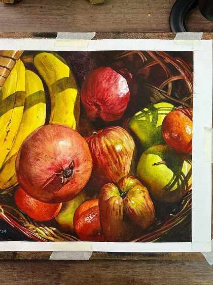 The fruit basket painting on my easel, showing the tape holding it to the board. This is a typical view of my workspace.