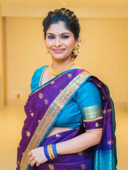 Keerthana looking elegant and beautiful for the naming ceremony. The purple and blue saree is a stunning combination.