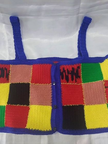 The full view of the Harry Styles inspired crochet crop top. It's a fun, vibrant piece that's perfect for anyone looking to add a pop of color and personality to their wardrobe.