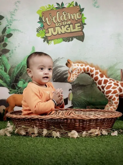 A happy, clapping baby enjoys his time in the studio jungle. We encourage play and interaction to capture the most natural and joyful expressions.