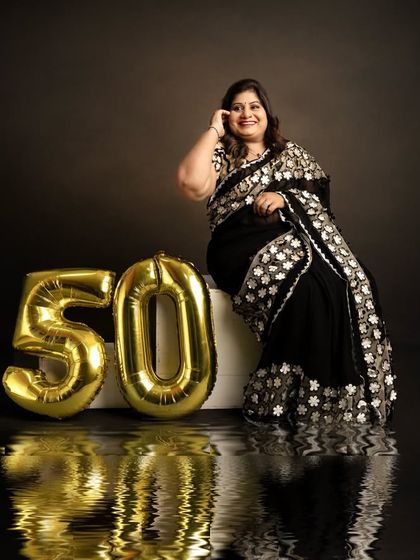 A creative shot using a reflective surface to add an artistic touch to this 50th birthday portrait. I love incorporating creative techniques to make milestone photos unique.