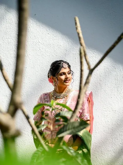 A creative bridal portrait of Srushti. I shot this through some bare branches to create an interesting foreground, framing her beautifully against the white wall and morning light.