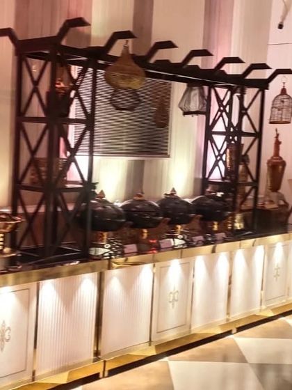 This station, designed for Pan-Asian cuisine, uses a dark overhead structure and black serving bowls to create a modern and dramatic food display.