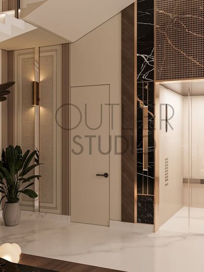 This image shows the lift lobby adjacent to the grand staircase. The material palette of marble, wood, and metal is consistent, creating a seamless transition between the different vertical circulation areas.