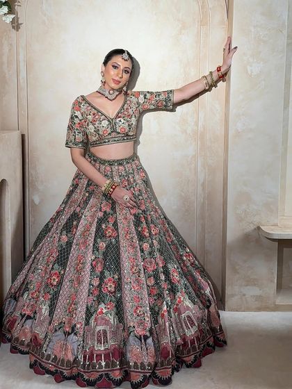 A full-length view of the floral lehenga, showcasing its grand skirt and the beautiful way the colors blend together. A perfect rental for a garden wedding or mehendi.