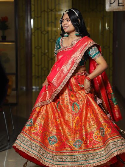 My beautiful Mehendi bride, Silky, in her full attire. The makeup was designed to complement her ornate red and orange banarasi lehenga without overpowering it.