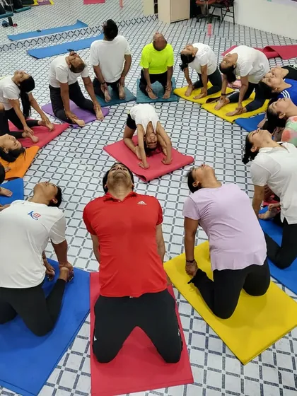 A creative group circle during our Yoga Day event at Kailash Health Village. This Camel Pose circle represents opening our hearts as a community.