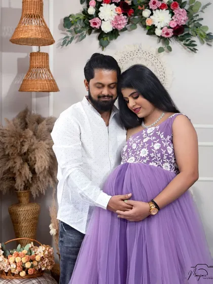A tender moment as he cradles her bump from behind. The love and connection between them are beautifully captured.