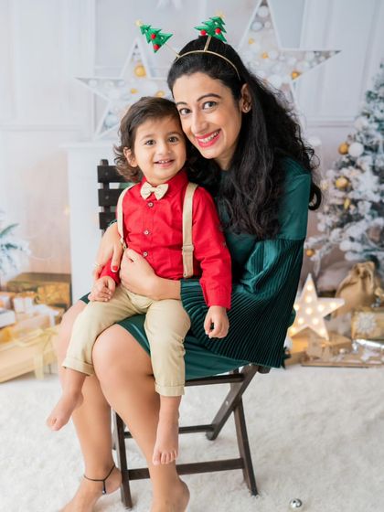A mother and her son looking dapper for their Christmas photos. The red and green outfits are perfectly festive.