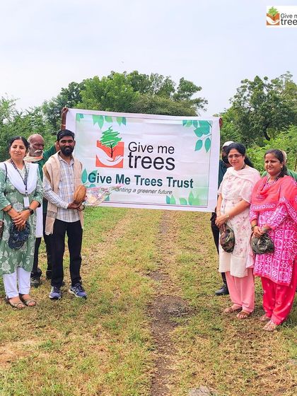 Our team and teachers from the school pose with the Give Me Trees banner before the massive plantation drive in Pune.