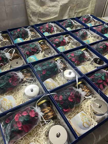 A look inside our royal blue and gold Roka return favor boxes. We filled them with premium almonds, our in-house Ganpati candles, potpourri, and a brass matki for a truly luxurious feel.