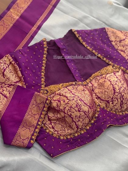 A purple blouse with gold brocade sleeves and a bustier-style front.