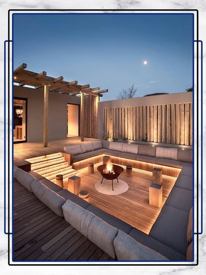 This sunken lounge with a central fire pit is the ultimate space for cozy evening gatherings. The built-in seating and ambient lighting create a warm and inviting atmosphere.