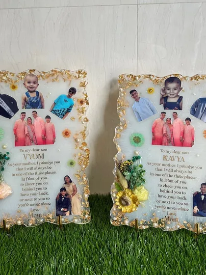 A pair of matching frames made for two sons from their mother, each with a heartfelt promise. They feature multiple photos and preserved flowers.