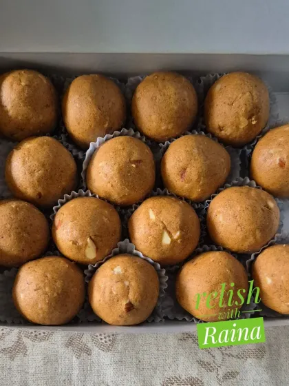 A detailed shot of Besan Laddoos with almond pieces. The crunch of the nuts perfectly complements the soft, melting texture of the laddoo.