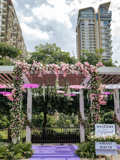 Another angle of the floral-wrapped pergola, showing the welcome sign and the beautiful natural surroundings. I design decor that complements the venue.