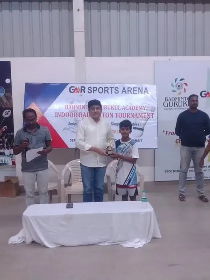 A young boy receives his trophy at the GMR Sports Arena tournament. We manage all logistical aspects of prize ceremonies.