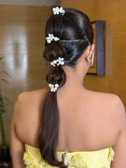 A back view of the sleek bubble braid, with pearl accessories adding a touch of class.