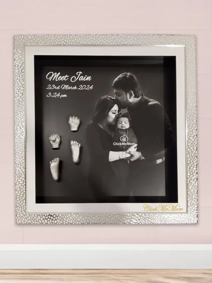 For a modern and heartfelt tribute, I can combine your family's first portrait with the delicate silver casts of your baby’s hands and feet. This design features a stunning silver textured frame and a classic black and white photograph, creating a sophisticated piece of art for your home.