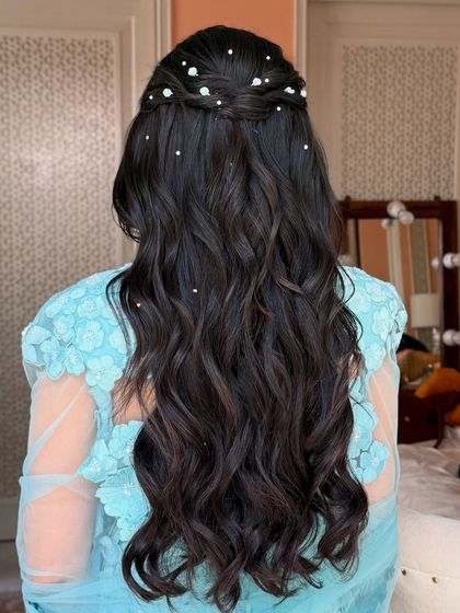 The back view of the half-up style, with pearls scattered through the hair like stars.
