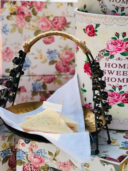 Classic finger sandwiches served in a charming, rustic basket. This is a perfect addition to a high-tea menu or a daytime event, presented with a touch of floral elegance.