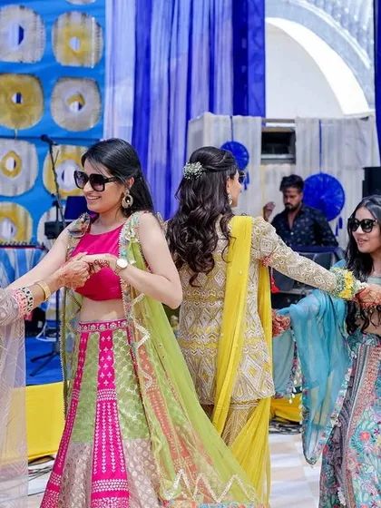 The bride's family looking stylish and having a blast during a mehendi flashmob. We love creating these candid, fun moments where everyone can let loose and just dance.