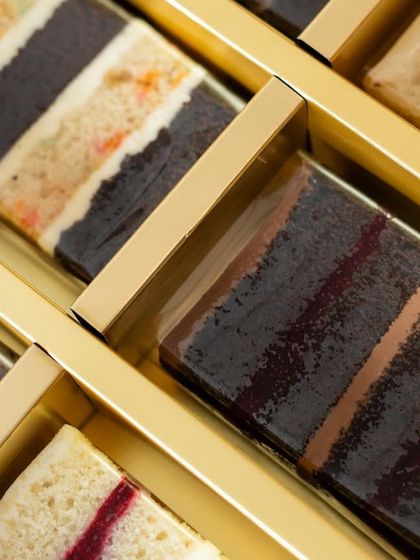 A close-up of the cake slices nestled in their box. We make sure they are packed securely to arrive in perfect condition.