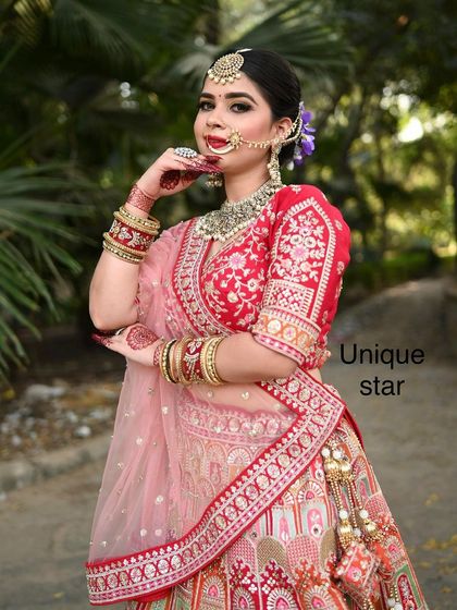 A classic portrait of a model in our red and pink lehenga, perfect for a bridal or pre-bridal photoshoot.
