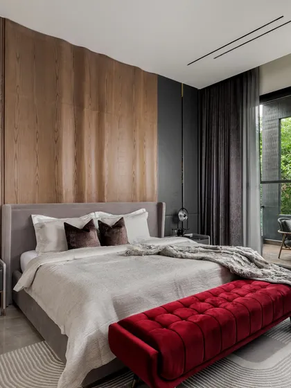 Another angle of the son's bedroom, showing the full effect of the statement wooden wall panel behind the bed. The dark grey accent wall and curtains create a moody, stylish atmosphere.