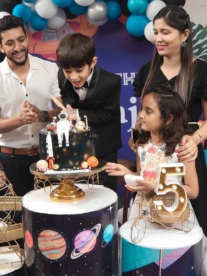 A thrilling 'Avengers' themed birthday party, with superhero cutouts, a cityscape backdrop, and dynamic balloon arrangements, ready for action.