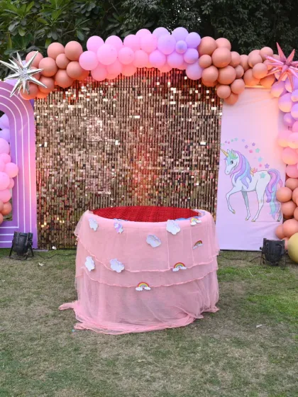 Another shot of the unicorn party, highlighting the sequin backdrop and custom cake table.