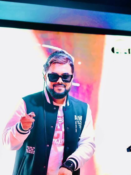 Tapping into the universal language of rhythm. A smiling, happy shot of me pointing to the crowd from the DJ booth.